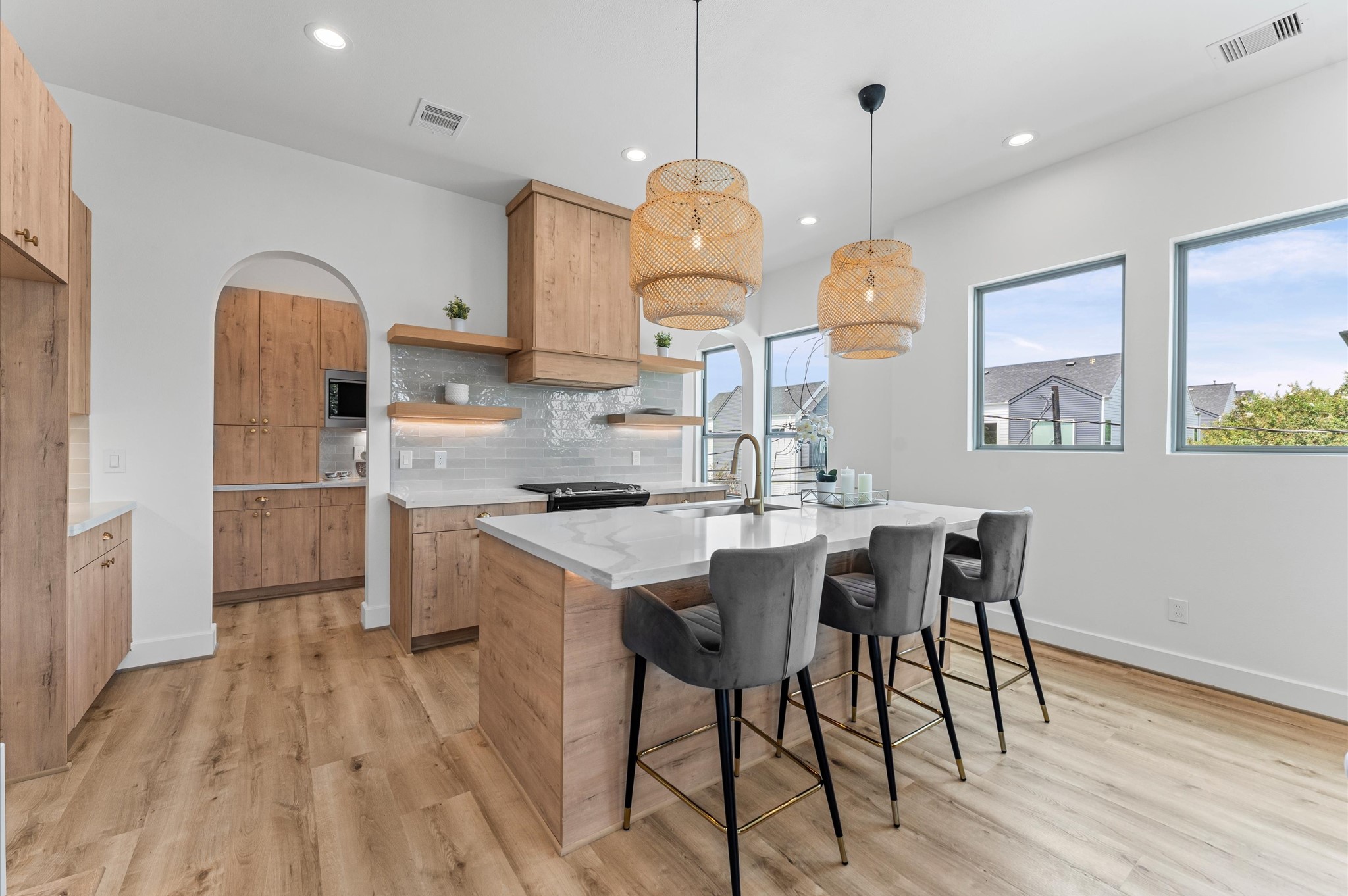 a kitchen with stainless steel appliances granite countertop a kitchen island a stove a table and chairs in it