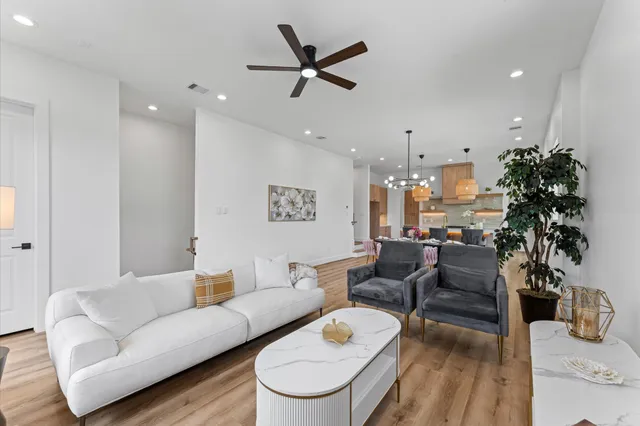 a living room with furniture and a potted plant