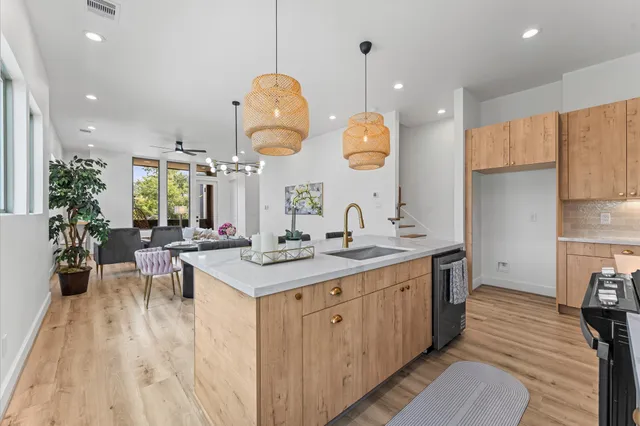 a kitchen with a sink a counter space appliances and cabinets