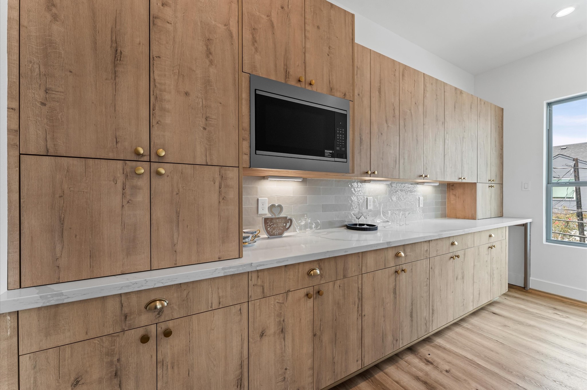 1122 West 17th Street, Unit D Houston, TX 77008 - Photo 16 of 37 a kitchen with stainless steel appliances granite countertop white cabinets a microwave oven and a sink