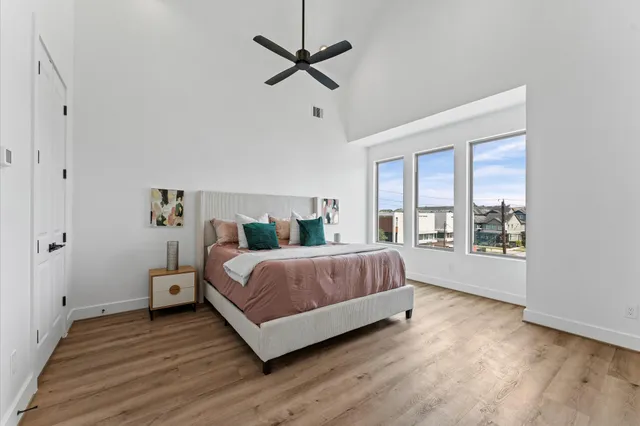 a spacious bedroom with a bed and a large window