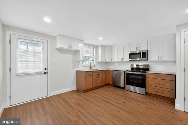 a open kitchen with a refrigerator stove top oven and sink