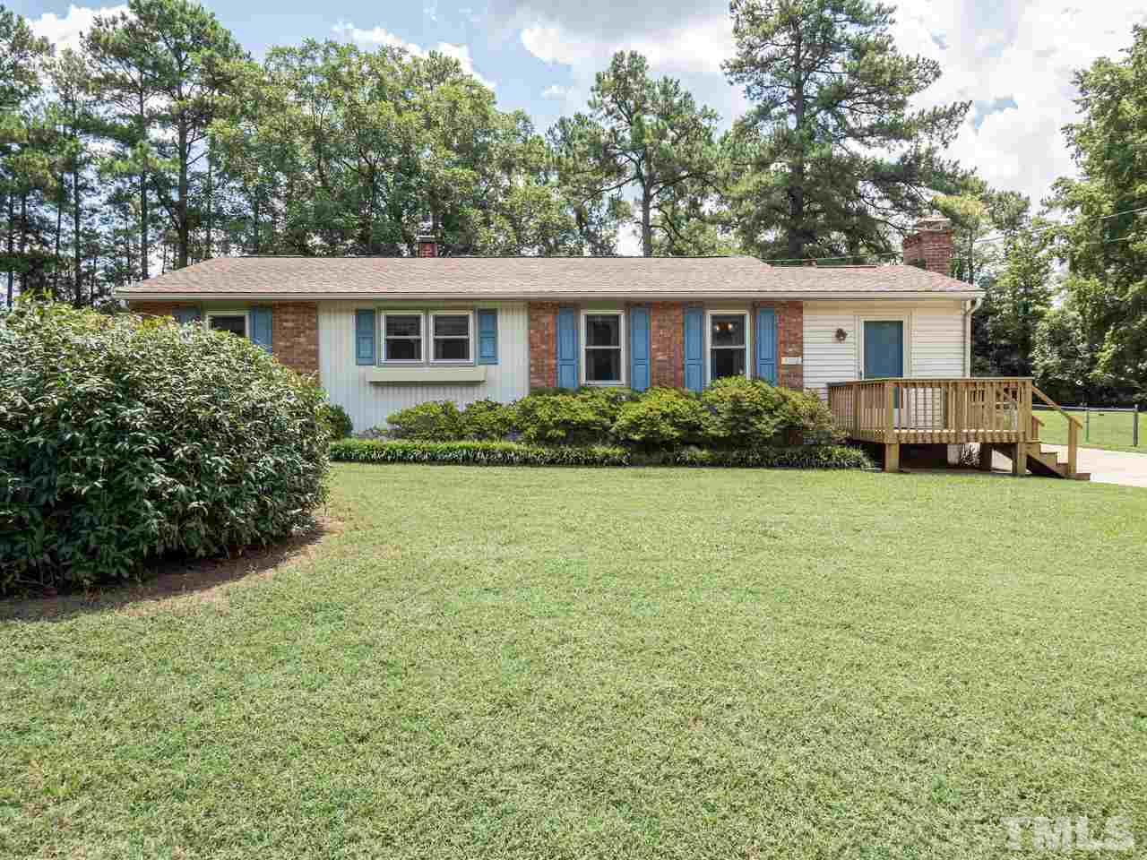 3308 Apache Drive Raleigh, NC 27609 - Photo 1 of 29 a view of a yard in front of a house with plants and large tree