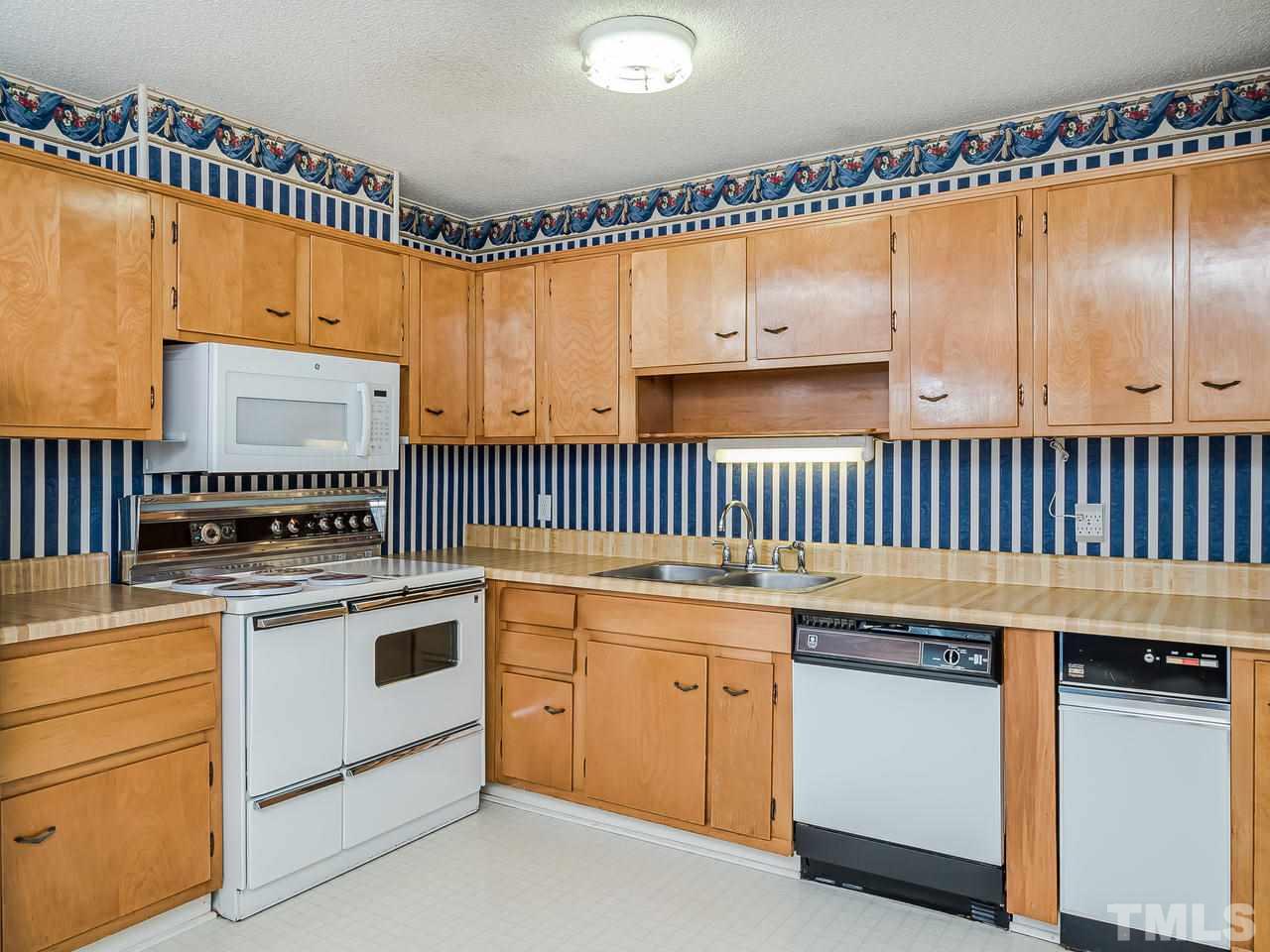 3308 Apache Drive Raleigh, NC 27609 - Photo 12 of 29 a kitchen with granite countertop cabinets a sink and a stove