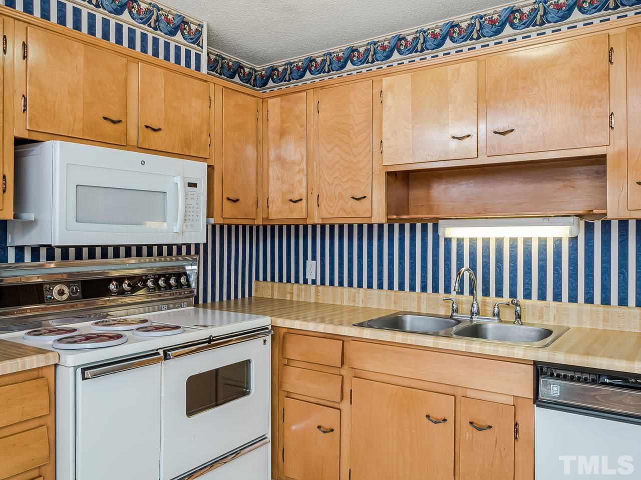 3308 Apache Drive Raleigh, NC 27609 - Photo 13 of 29 a kitchen with granite countertop a sink stove and cabinets