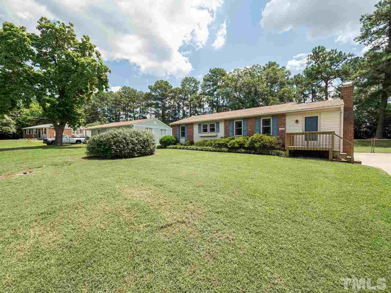 3308 Apache Drive Raleigh, NC 27609 - Photo 3 of 29 a view of a house with a big yard and potted plants and large trees