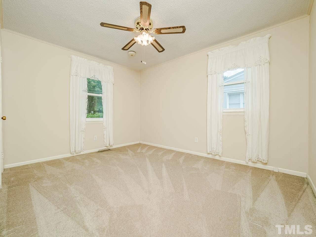 3308 Apache Drive Raleigh, NC 27609 - Photo 22 of 29 an empty room with windows and fan