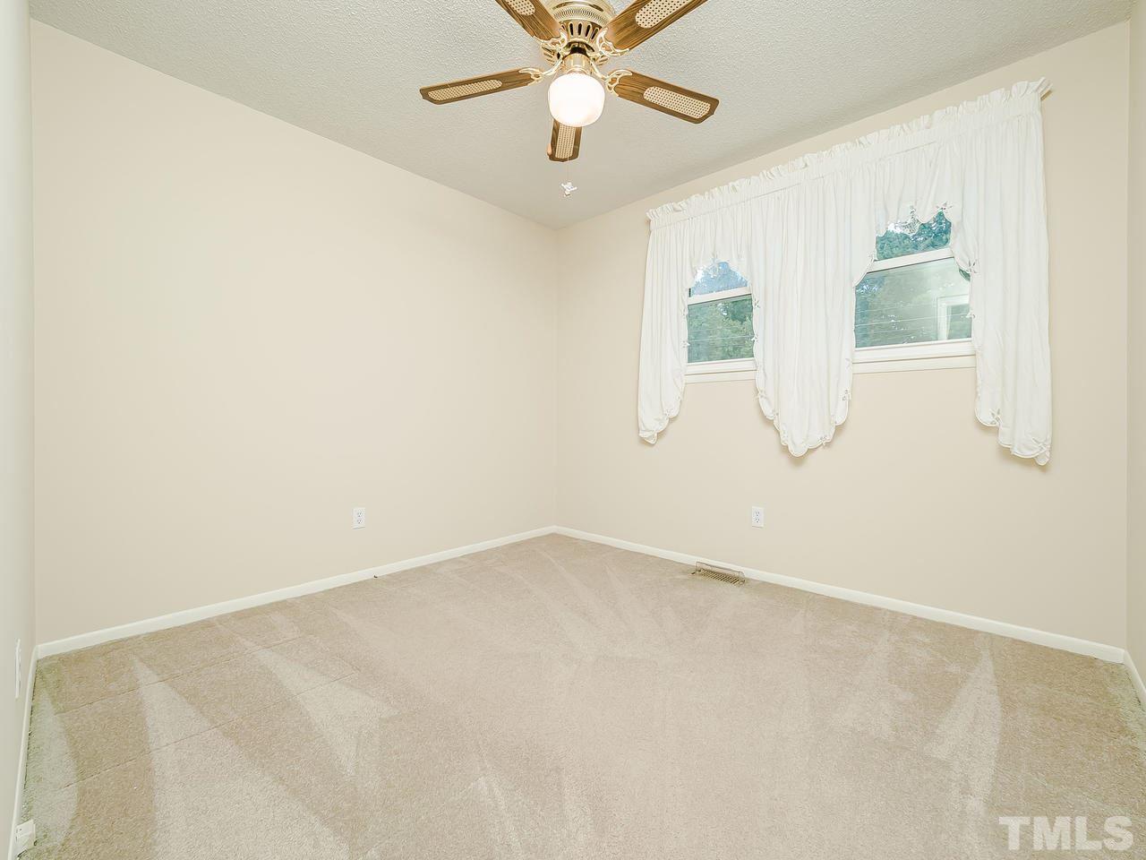 3308 Apache Drive Raleigh, NC 27609 - Photo 24 of 29 an empty room with a window and a fan