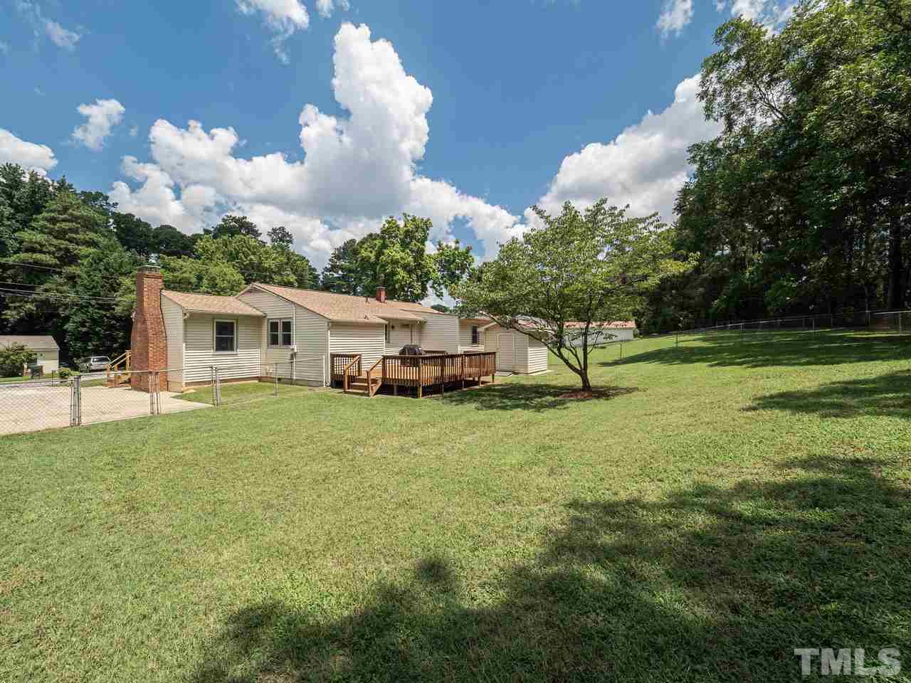 3308 Apache Drive Raleigh, NC 27609 - Photo 28 of 29 a big white house with a big yard and large trees