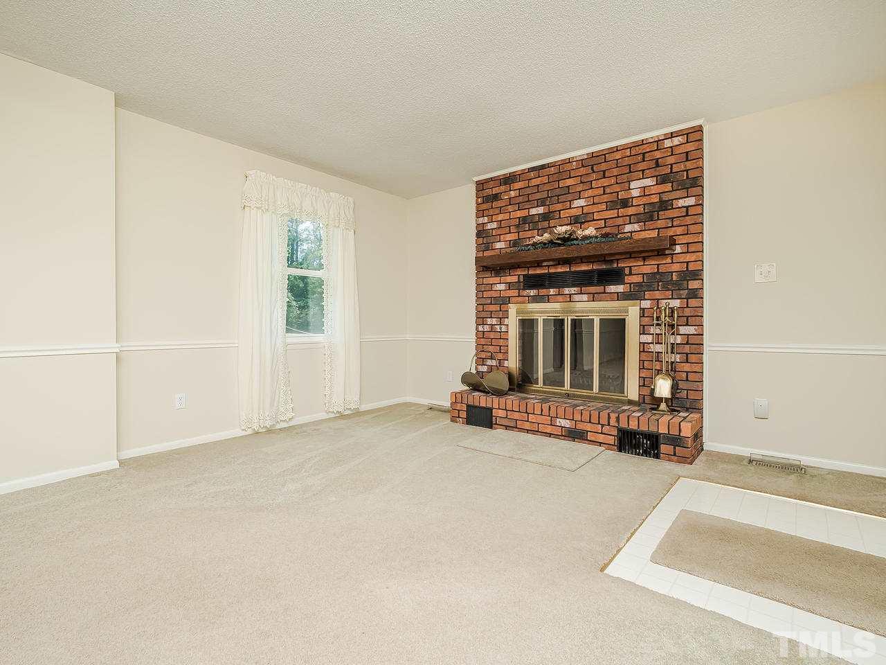 3308 Apache Drive Raleigh, NC 27609 - Photo 5 of 29 an empty room with fireplace