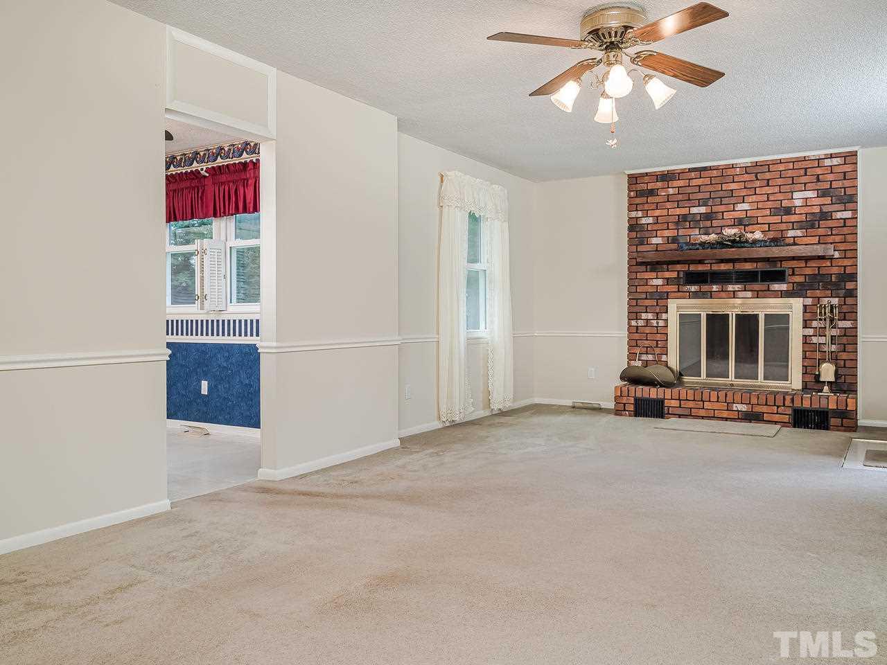 3308 Apache Drive Raleigh, NC 27609 - Photo 8 of 29 an empty room with windows and fireplace