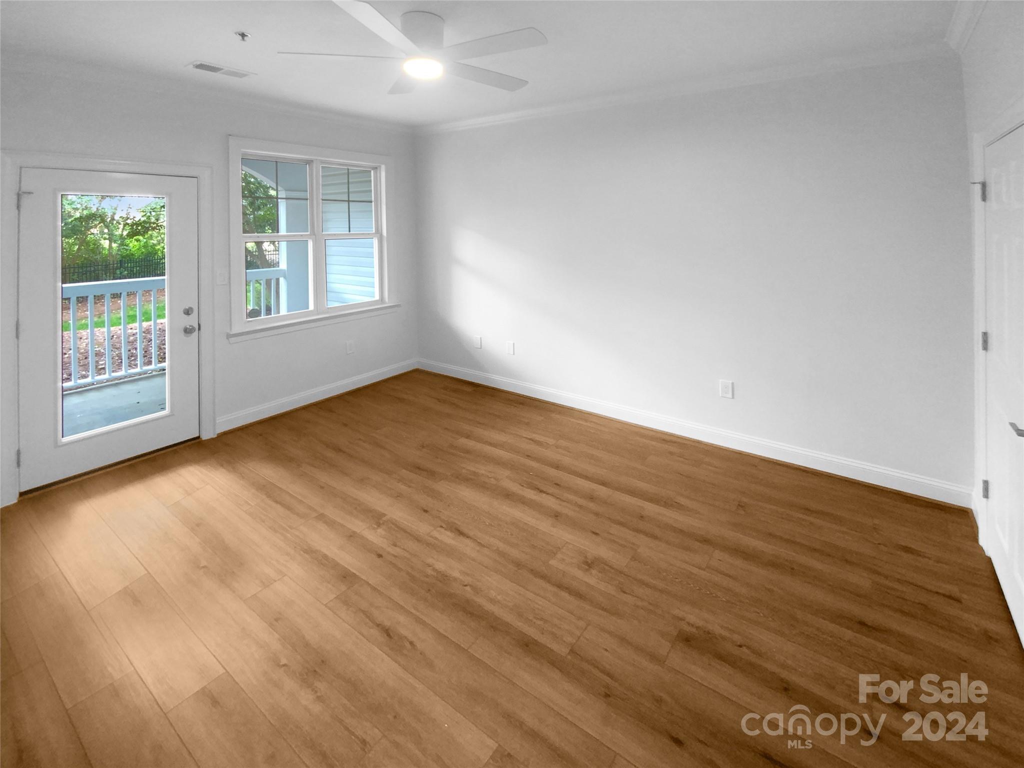 5601 Fairview Road, Unit 5 Charlotte, NC 28209 - Photo 12 of 16 an empty room with wooden floor and windows