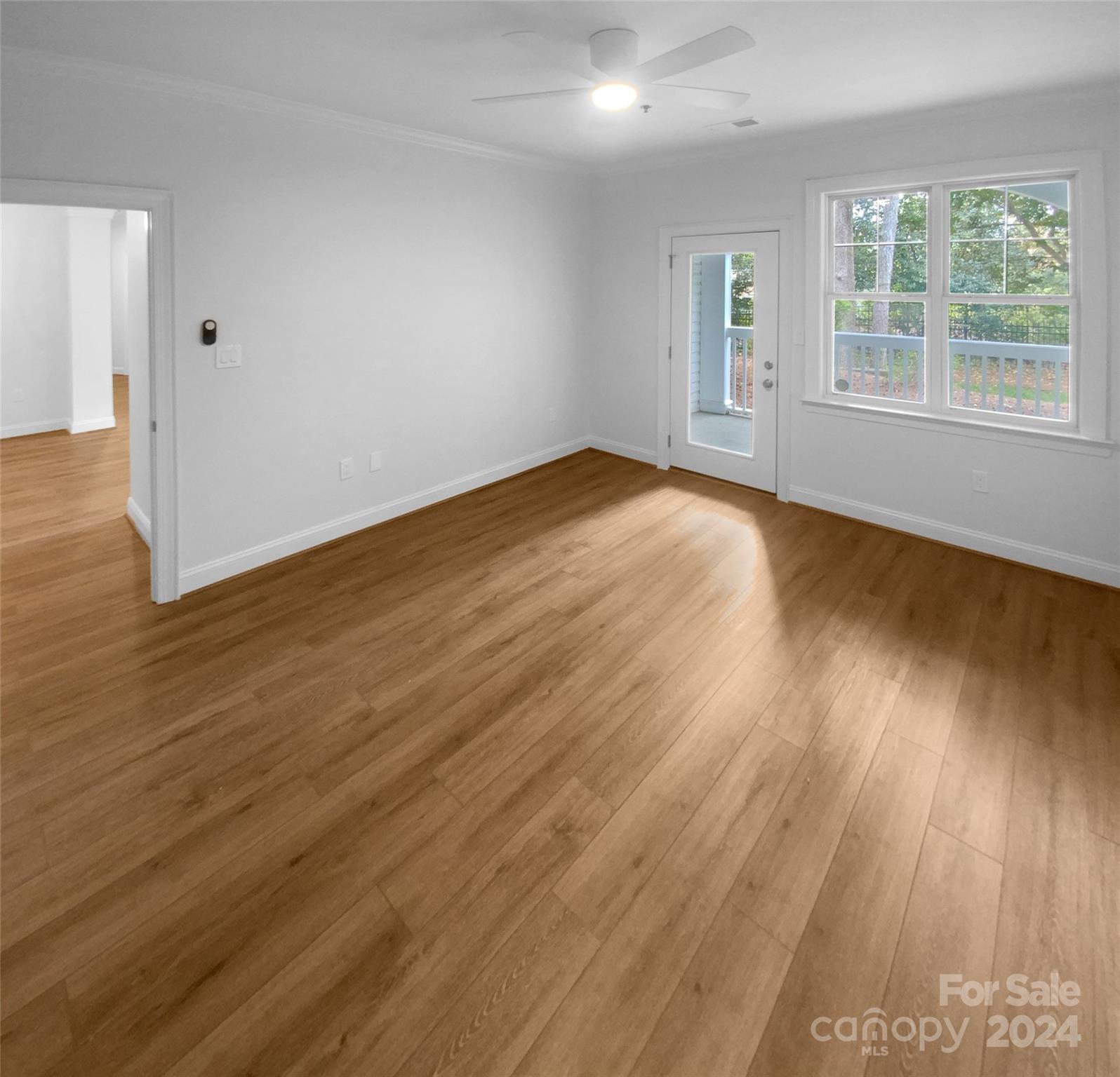 5601 Fairview Road, Unit 5 Charlotte, NC 28209 - Photo 13 of 16 an empty room with wooden floor and windows