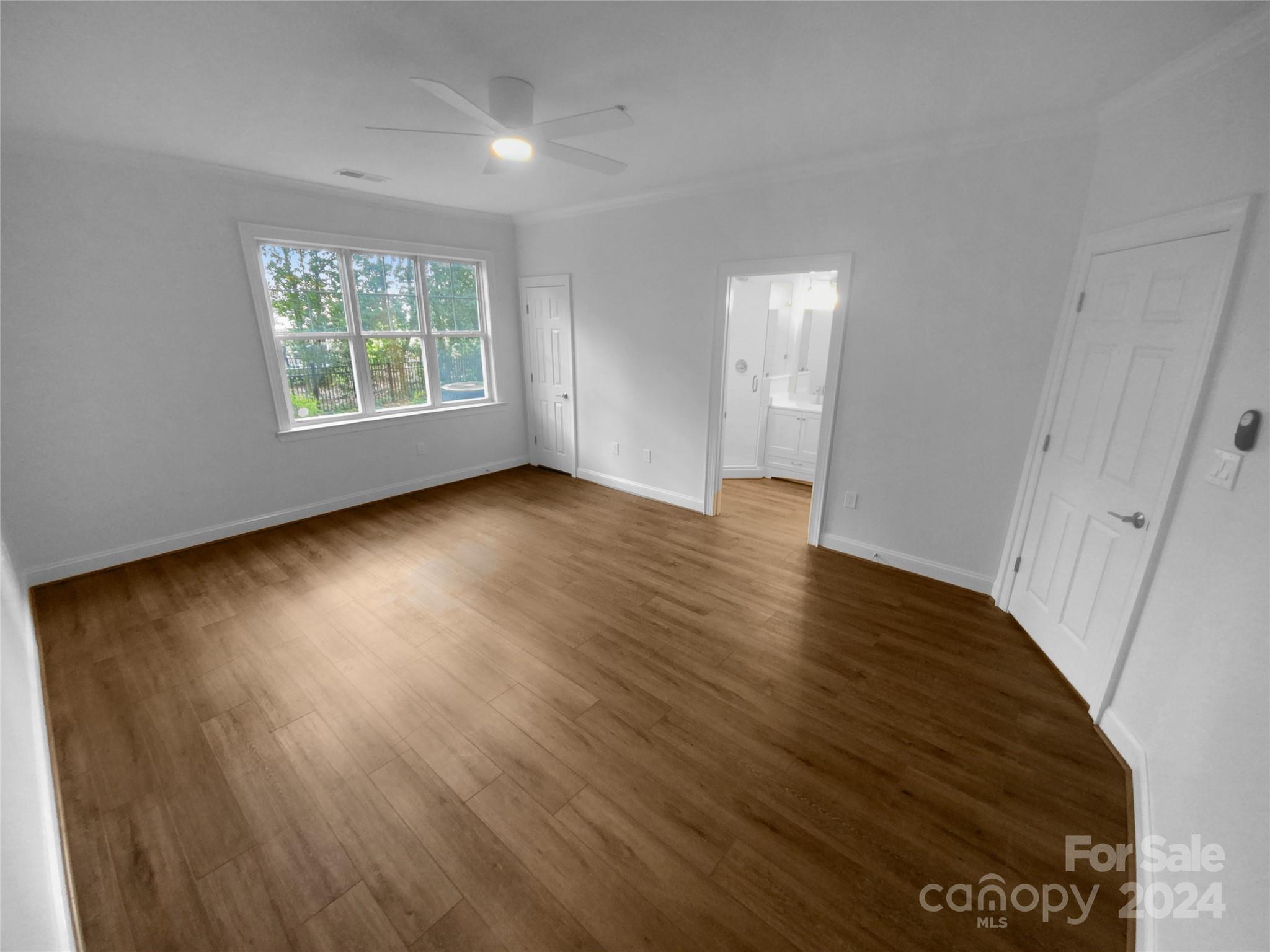 5601 Fairview Road, Unit 5 Charlotte, NC 28209 - Photo 3 of 16 an empty room with wooden floor and windows