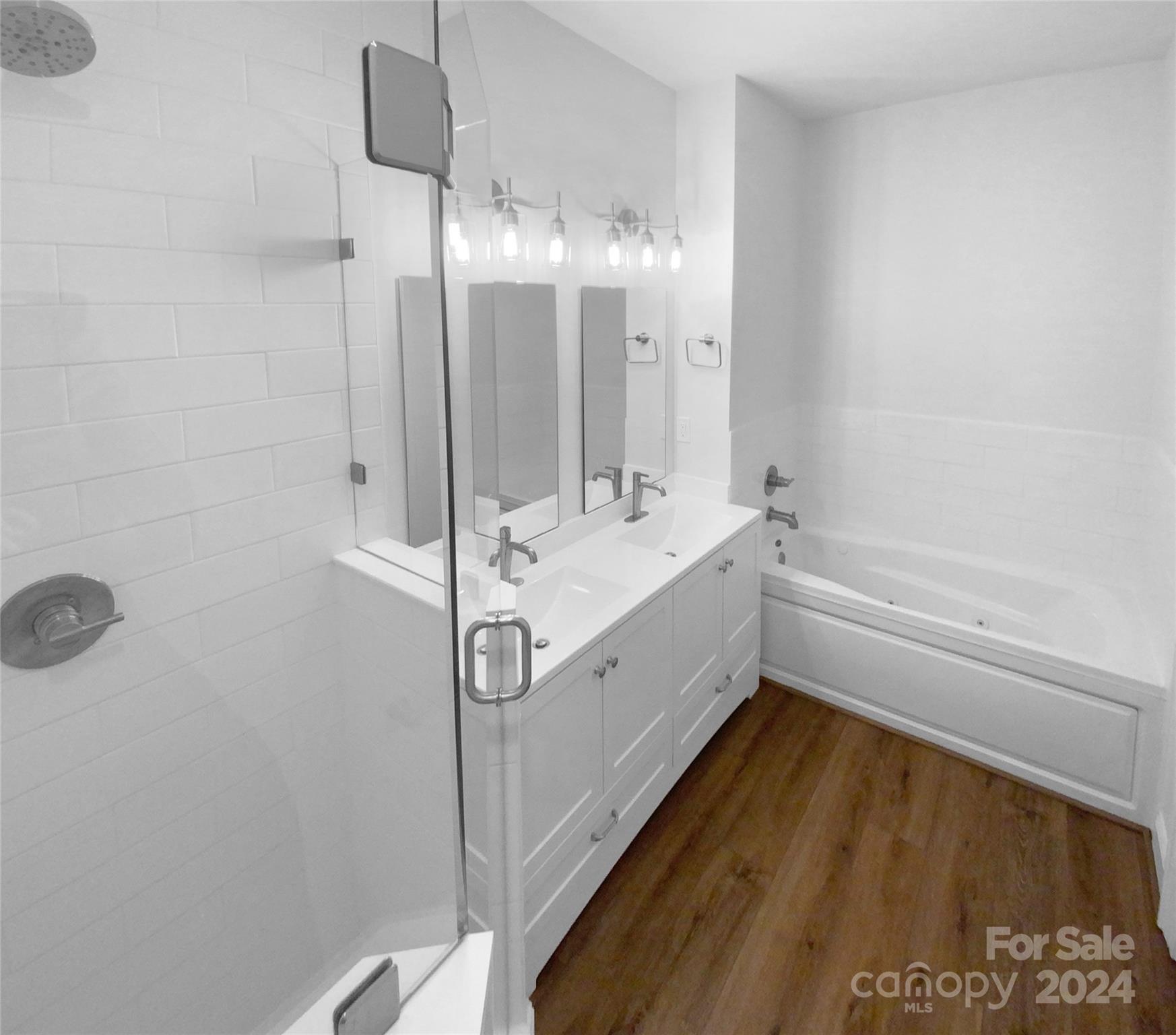 5601 Fairview Road, Unit 5 Charlotte, NC 28209 - Photo 5 of 16 a bathroom with a sink a mirror and a bathtub
