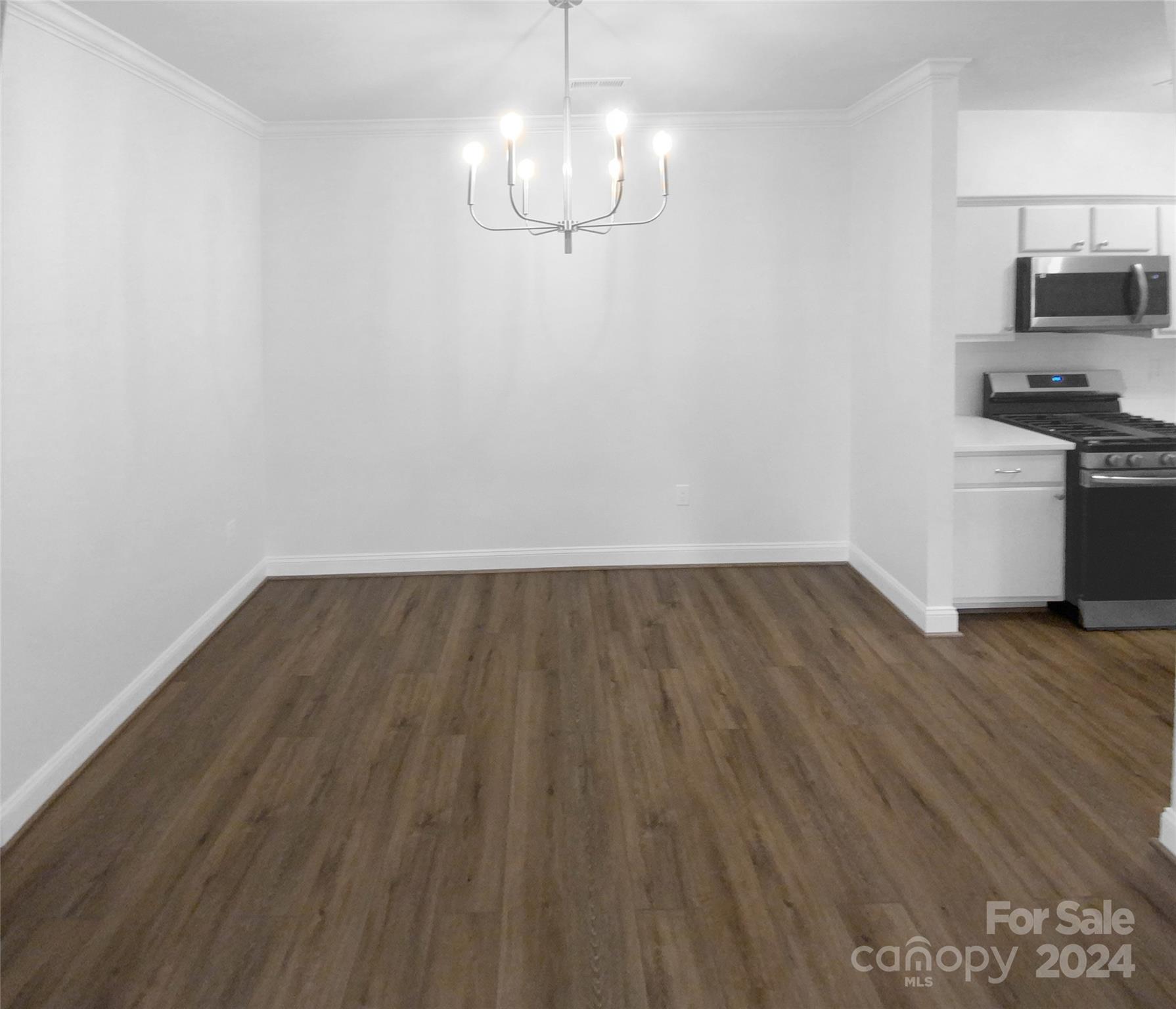 5601 Fairview Road, Unit 5 Charlotte, NC 28209 - Photo 8 of 16 a view of a room with wooden floor and stainless steel appliances