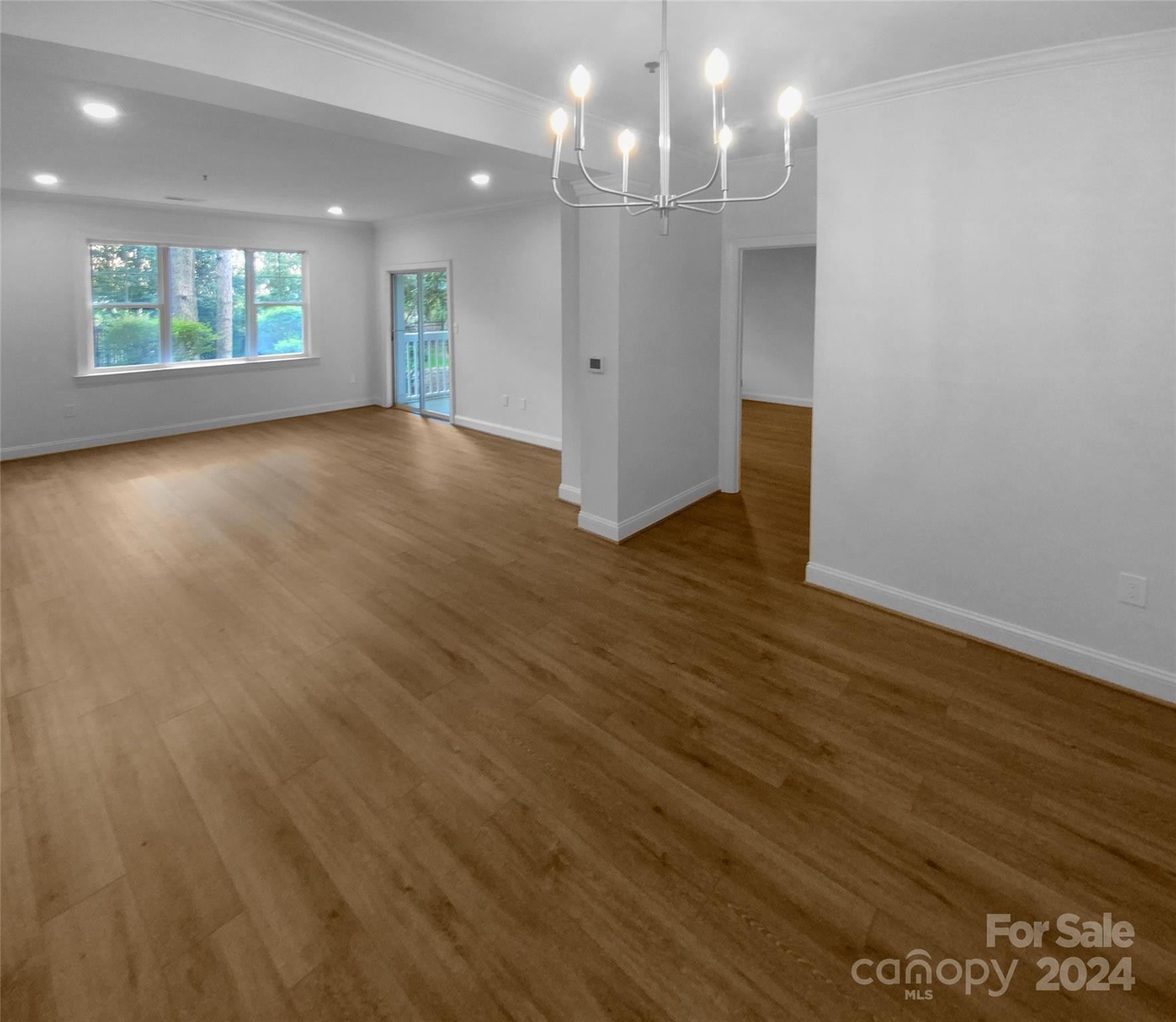 5601 Fairview Road, Unit 5 Charlotte, NC 28209 - Photo 9 of 16 an empty room with wooden floor and windows