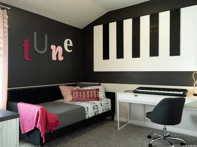 a bedroom with a bed and a desk