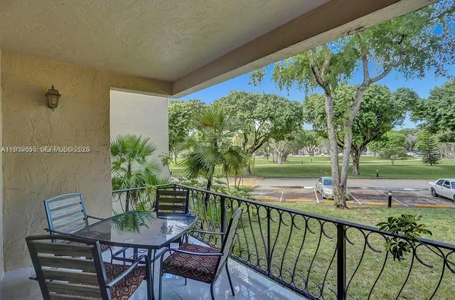 a view of a chairs and table in patio