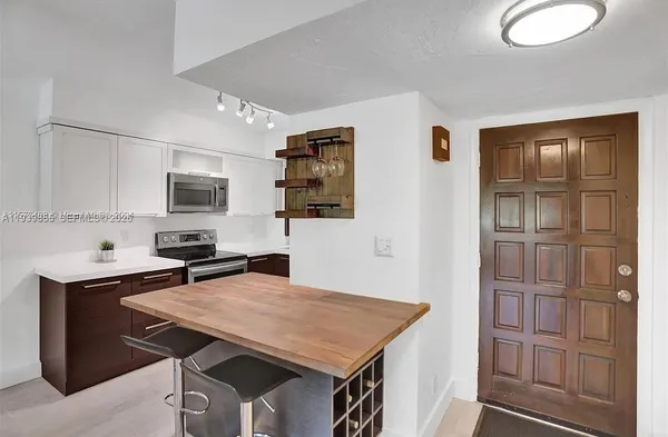 a view of a kitchen with a sink and cabinets