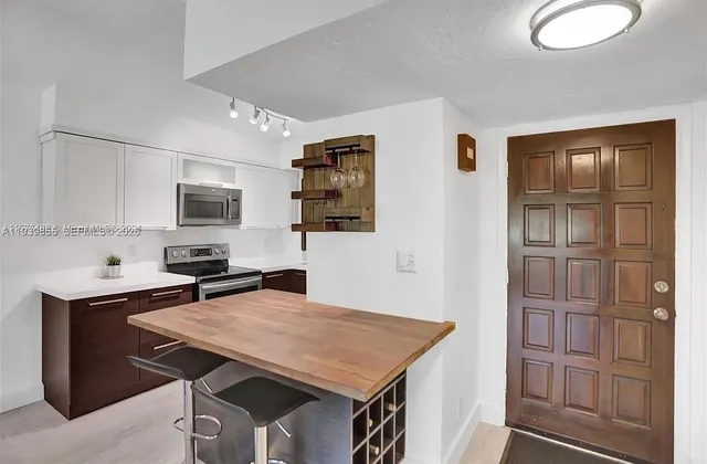 a view of a kitchen with a sink and cabinets