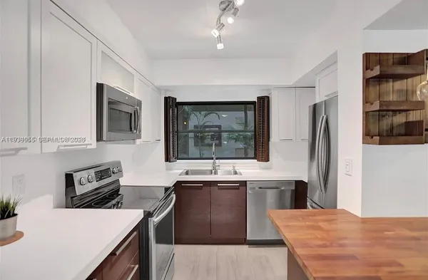 a kitchen with a stove a refrigerator and a sink