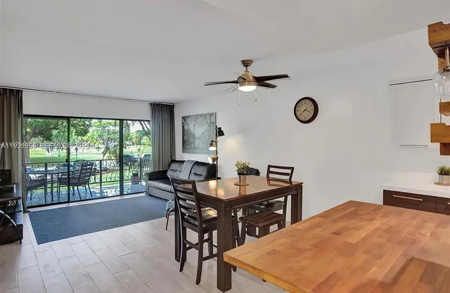 a living room with a table and a clock