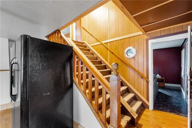 a kitchen with stainless steel appliances granite countertop a sink cabinets and wooden floor