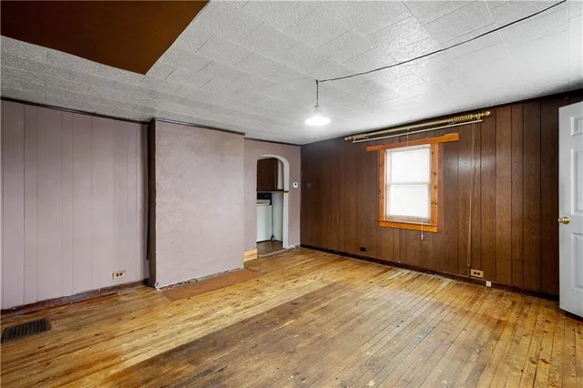 a view of a bedroom with furniture and a window