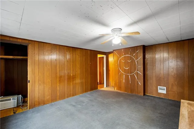 a view of backyard with wooden fence