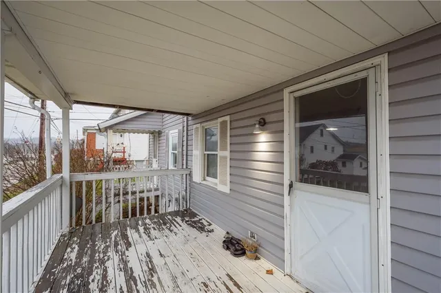 a view of a balcony with wooden floor