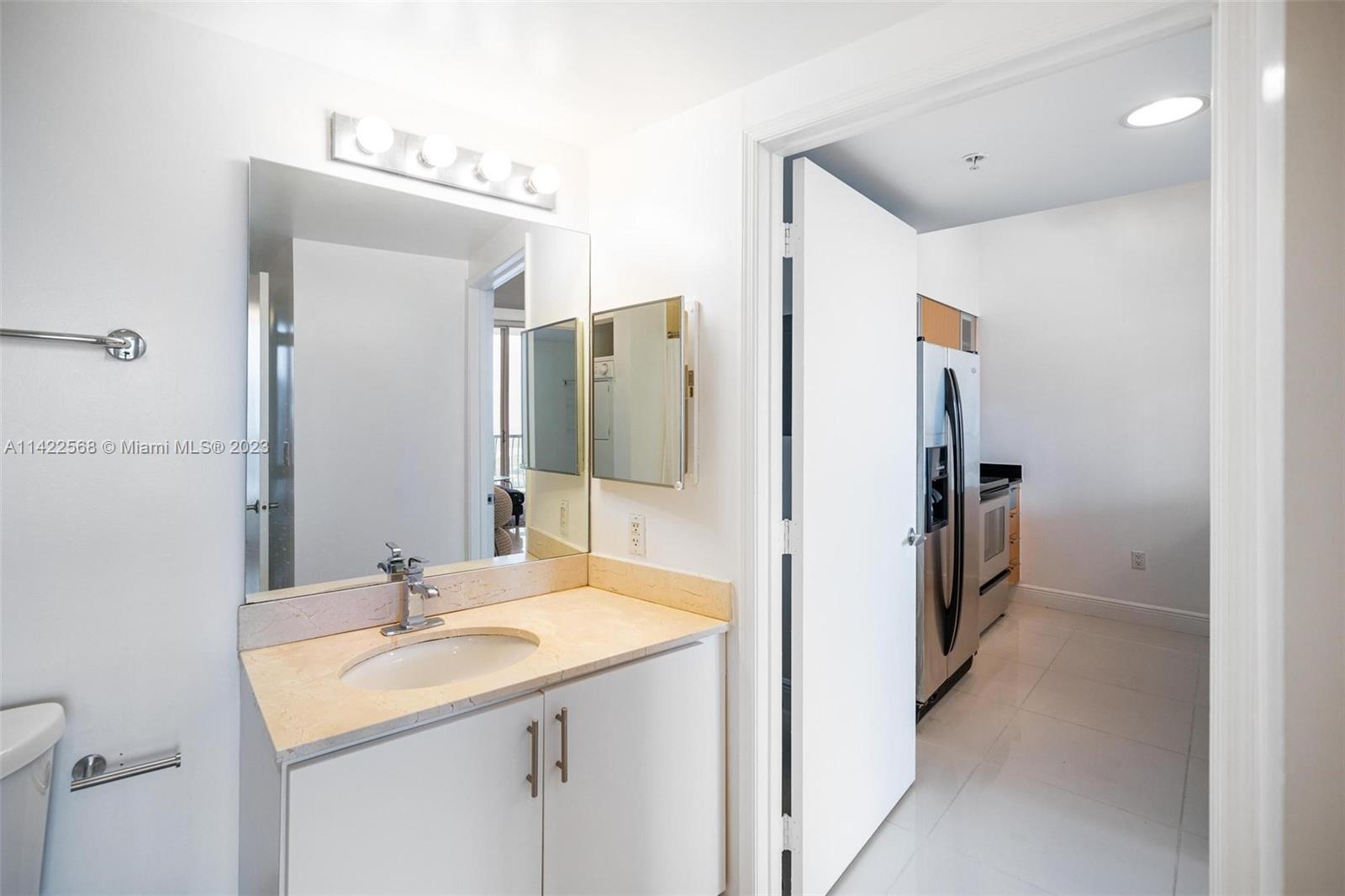 Edgewater Miami, FL 33132 - Photo 16 of 23 a bathroom with a sink and a mirror