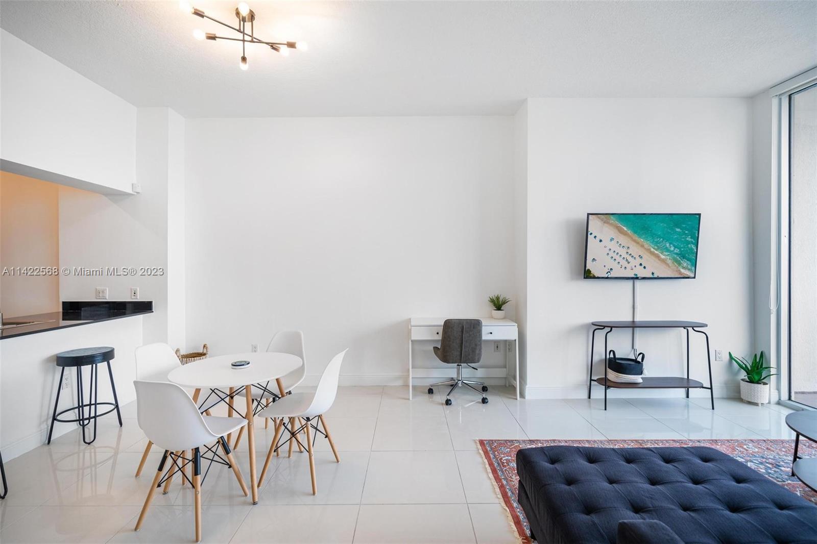 Edgewater Miami, FL 33132 - Photo 3 of 23 a dining room with furniture and a couch