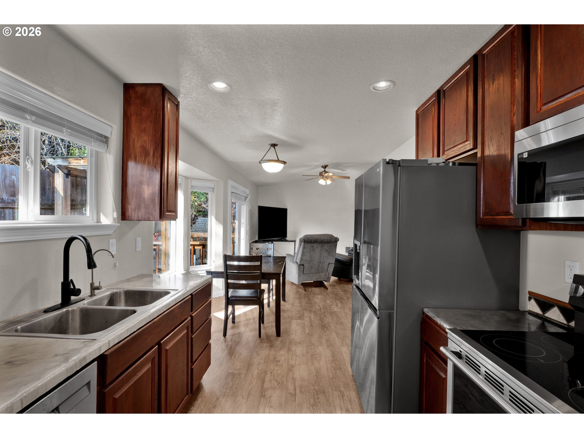 76554 Bobbe Way Oakridge, OR 97463 - Photo 12 of 47 a kitchen with sink refrigerator and cabinets