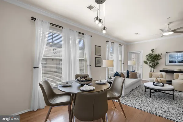 a view of living room with furniture a flat screen tv and floor to ceiling window
