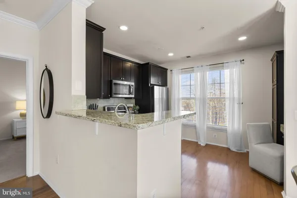 a kitchen with granite countertop a refrigerator stove and microwave