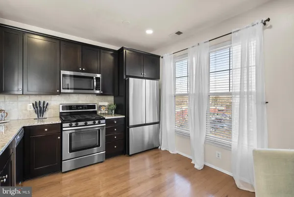 a kitchen with a refrigerator sink and microwave