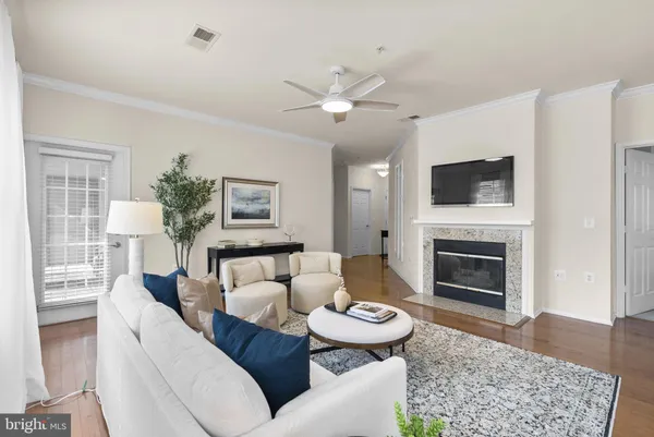 a living room with furniture a rug and a chandelier