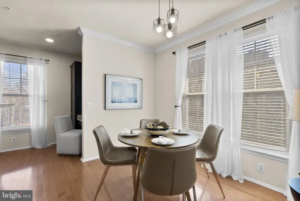 a view of a dining room with furniture and a kitchen