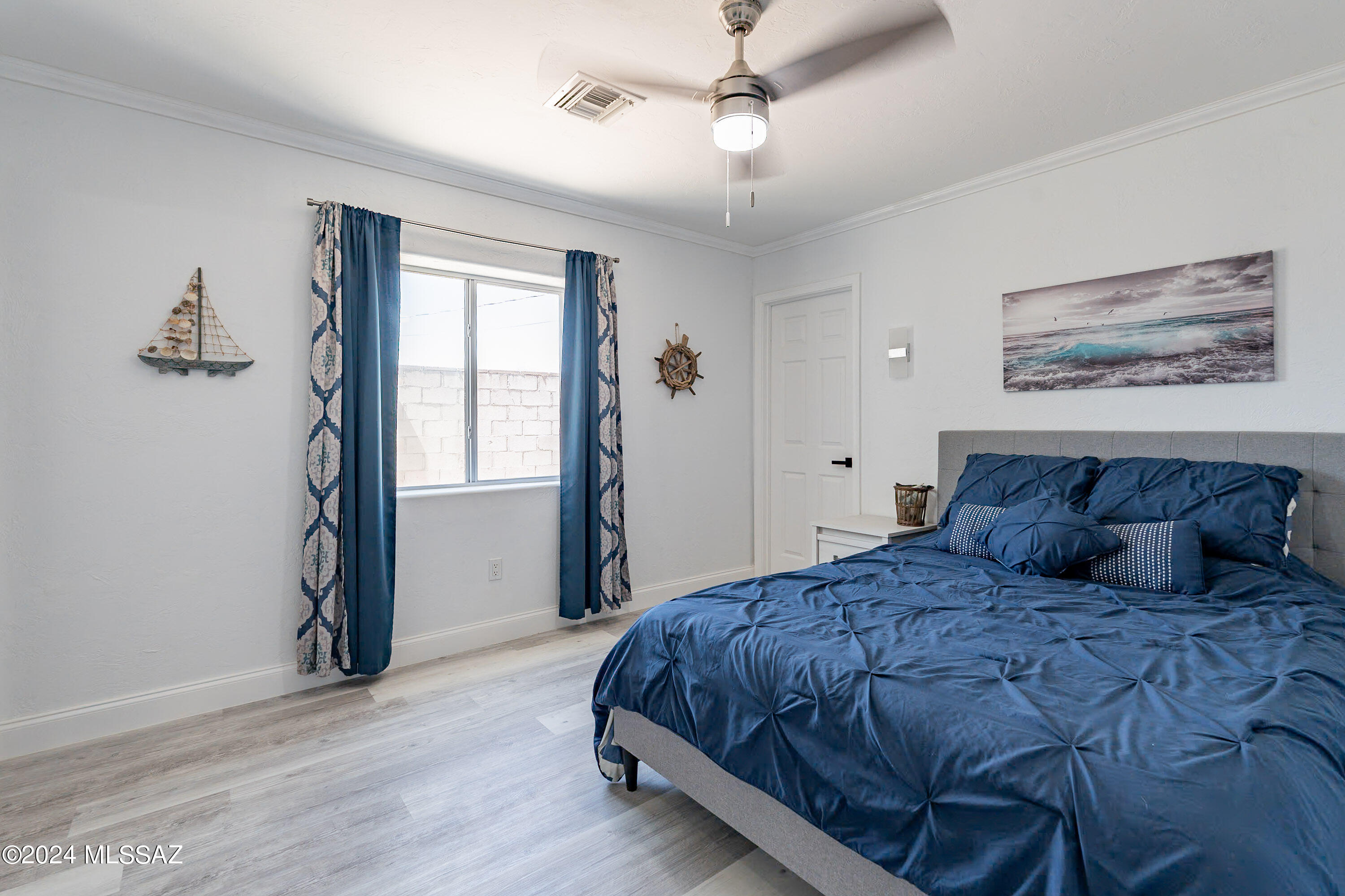 1009 Calle Coyote Rio Rico, AZ 85648 - Photo 16 of 28 a large bedroom with a bed and a window