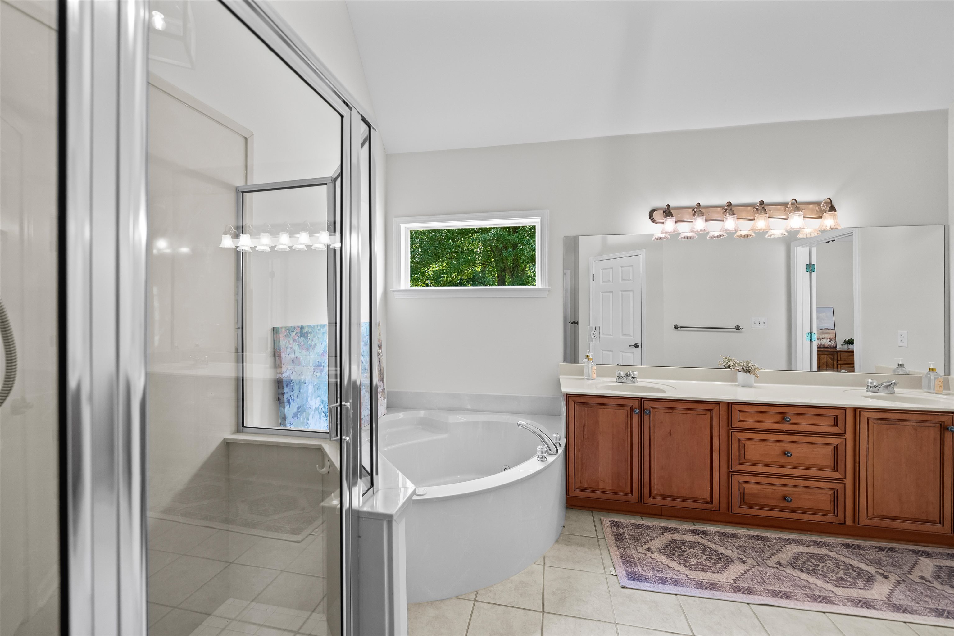 5035 Brian Ridge Road Arlington, TN 38002 - Photo 20 of 40 Bathroom featuring a glass-enclosed shower, a large soaking tub, and a dual vanity with wood cabinetry