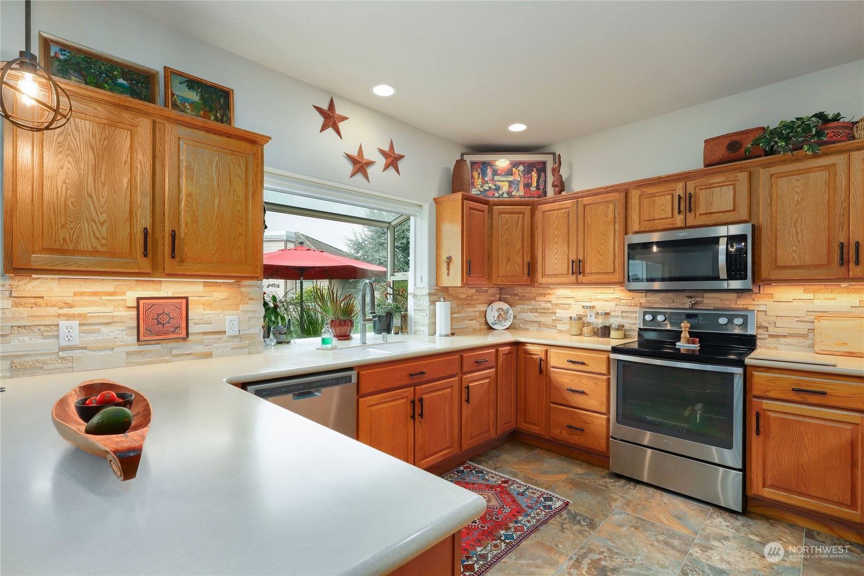 421 Blakely Boulevard Sequim, WA 98382 - Photo 11 of 35 a kitchen with a sink a stove and cabinets