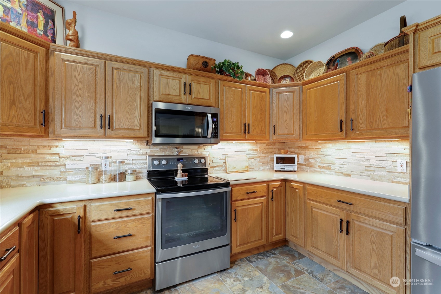 421 Blakely Boulevard Sequim, WA 98382 - Photo 12 of 35 a kitchen with granite countertop cabinets stainless steel appliances and a sink