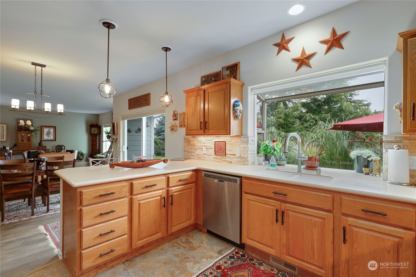 421 Blakely Boulevard Sequim, WA 98382 - Photo 13 of 35 a kitchen with a sink window and cabinets