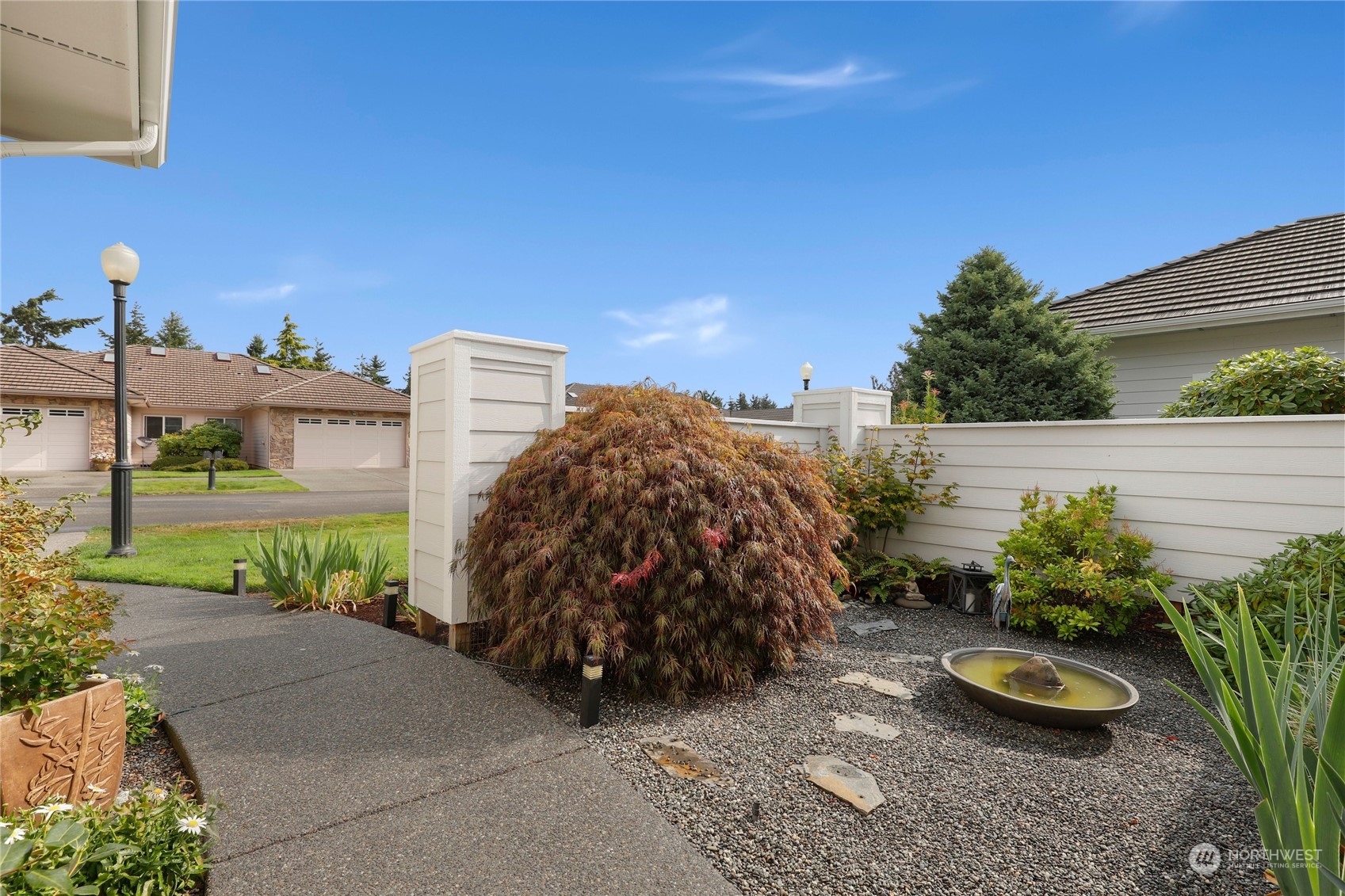 421 Blakely Boulevard Sequim, WA 98382 - Photo 32 of 35 a view of a garden with plants and a bench