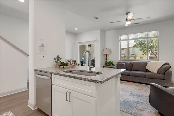a kitchen with granite countertop a sink and steel appliances
