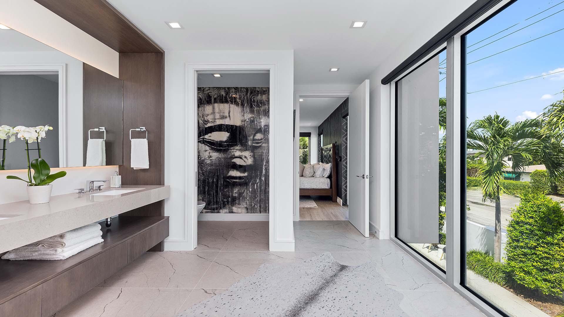 917 Bucida Road, Unit A Delray Beach, FL 33483 - Photo 15 of 36 a bathroom with a double vanity sink and a mirror