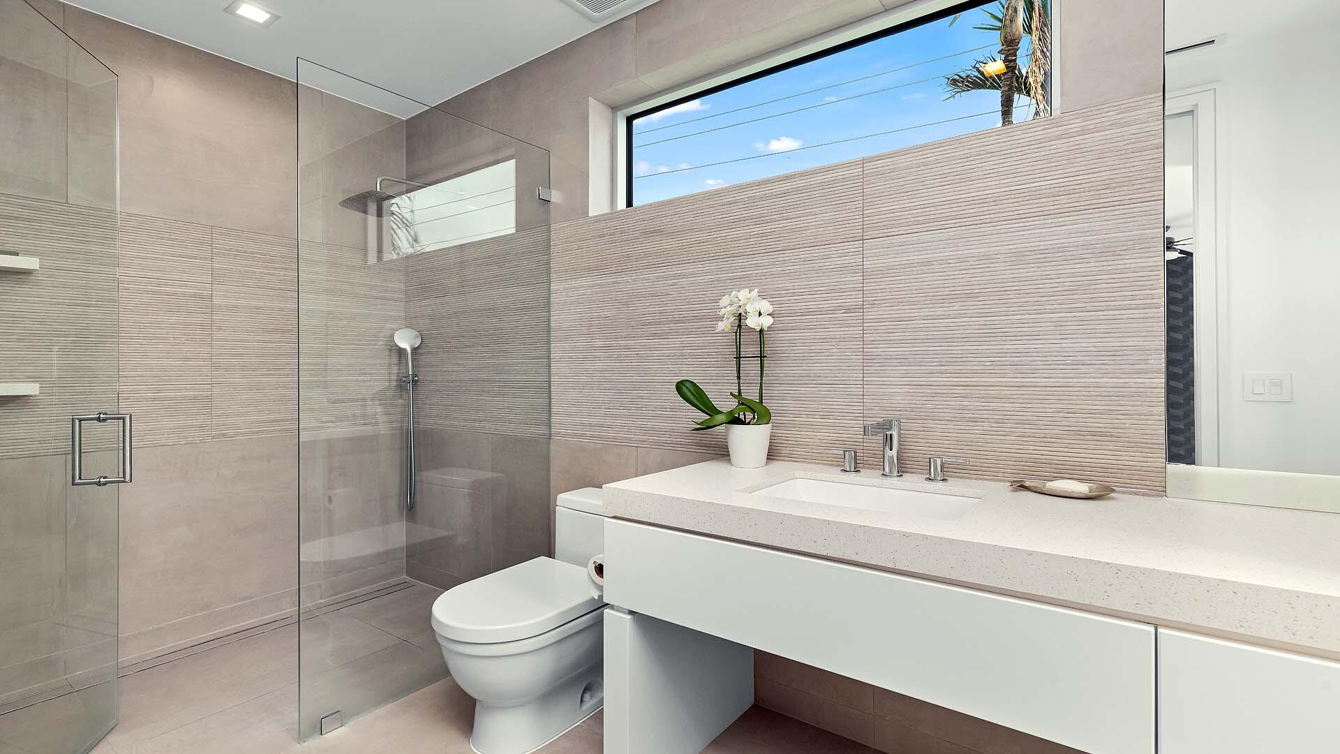 917 Bucida Road, Unit A Delray Beach, FL 33483 - Photo 21 of 36 a bathroom with a sink a toilet and shower