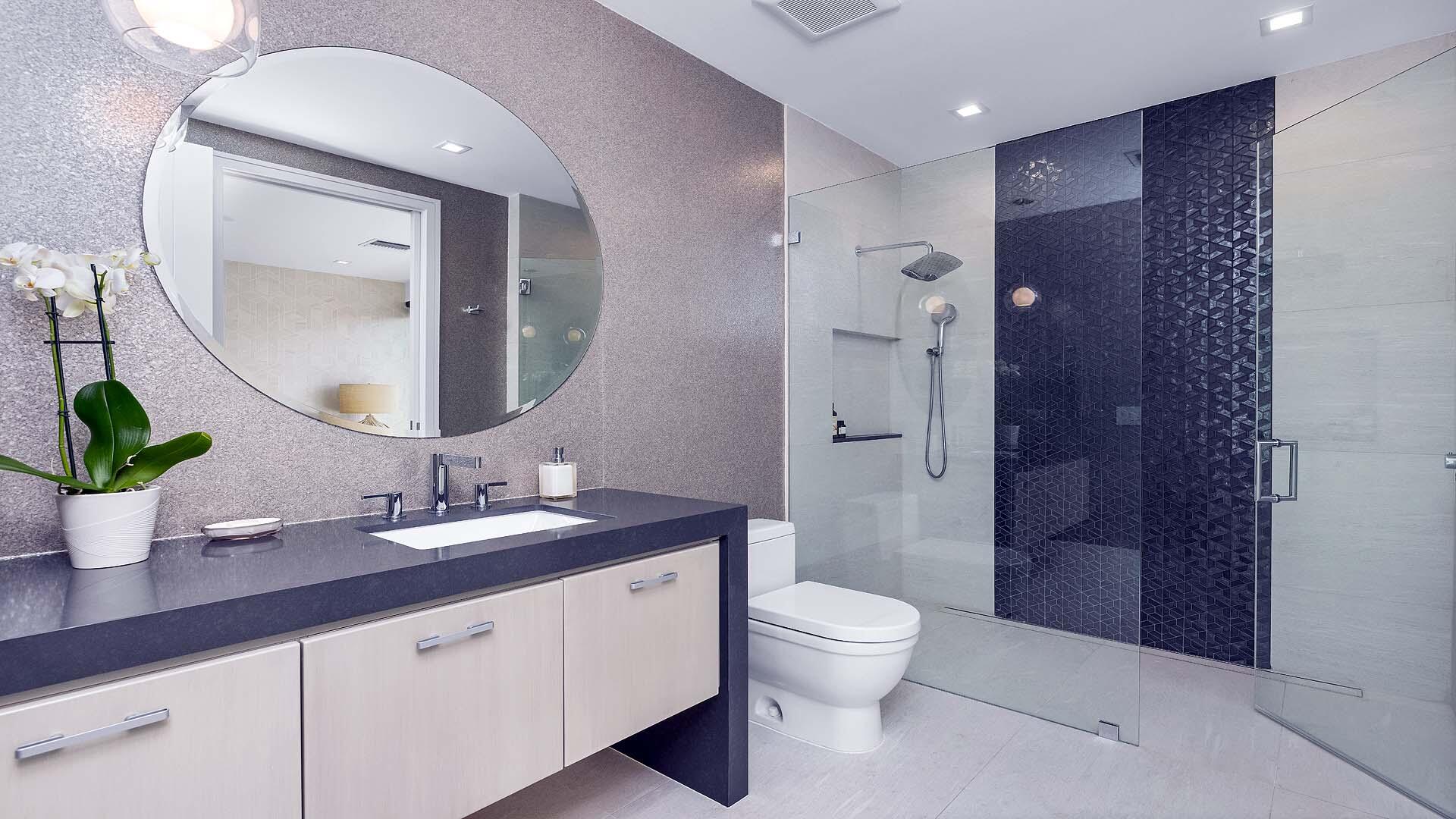 917 Bucida Road, Unit A Delray Beach, FL 33483 - Photo 25 of 36 a bathroom with a granite countertop sink a toilet a mirror and shower