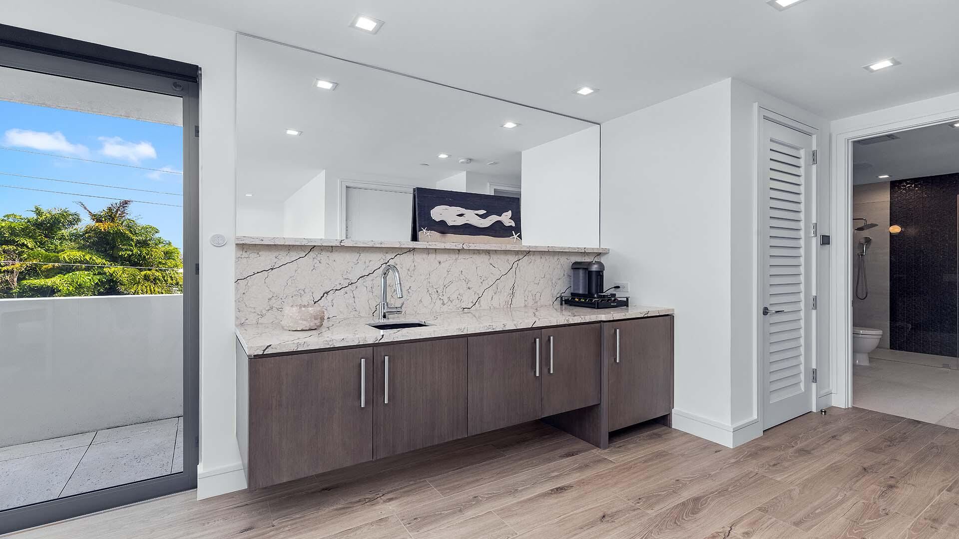 917 Bucida Road, Unit A Delray Beach, FL 33483 - Photo 28 of 36 a view of kitchen with stainless steel appliances granite countertop a sink and a refrigerator